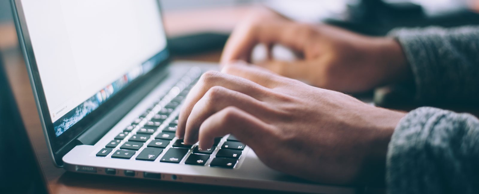 Person typing on laptop